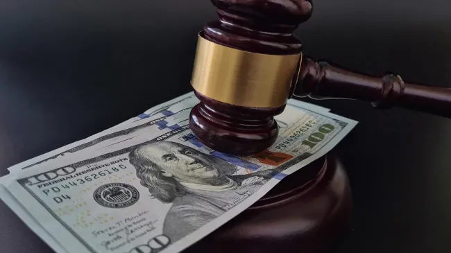 dollar bill and judge gavel